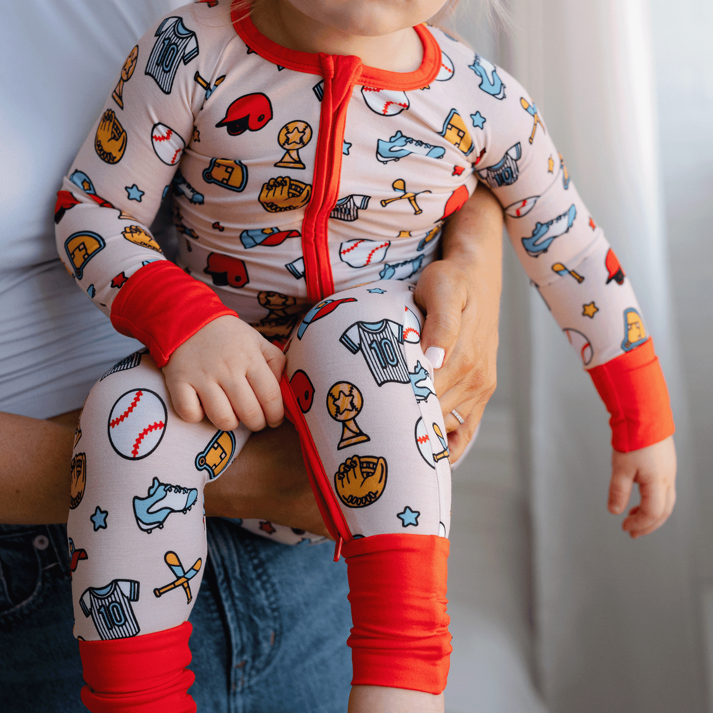 Baseball-themed baby one-piece with soft bamboo fabric, double zippers for easy changes, and a playful design for little fans.