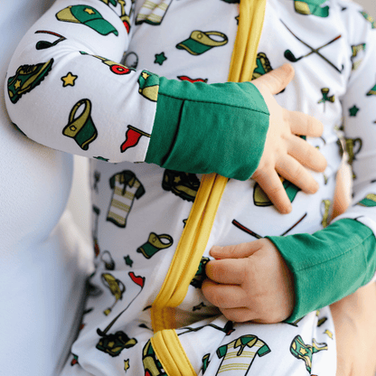 Golf-themed baby one-piece with soft bamboo fabric, double zippers for easy changes, and a playful design for little golf fans.