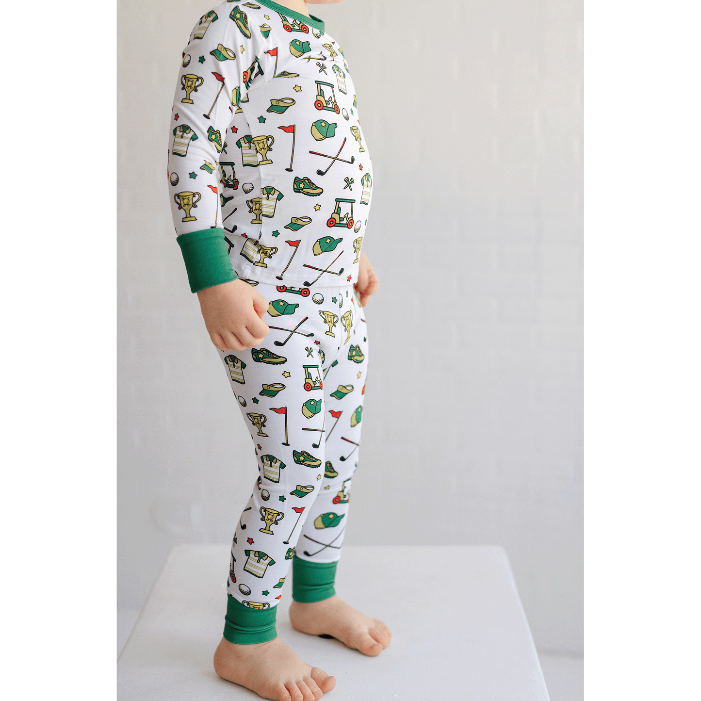 Golf-themed pajamas for toddler to youth sizes, made with soft bamboo fabric for a cozy and comfortable sleep.