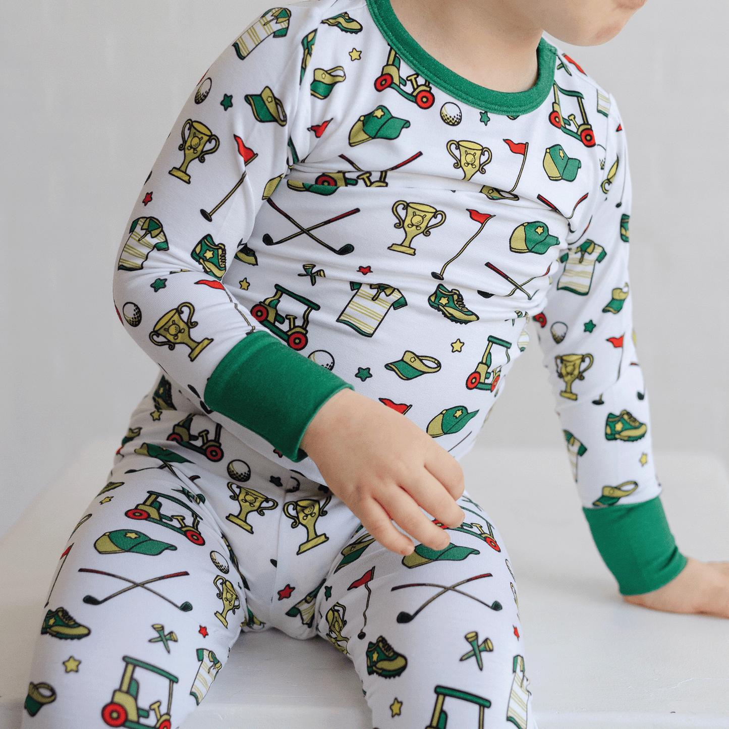 Golf-themed pajamas for toddler to youth sizes, made with soft bamboo fabric for a cozy and comfortable sleep.