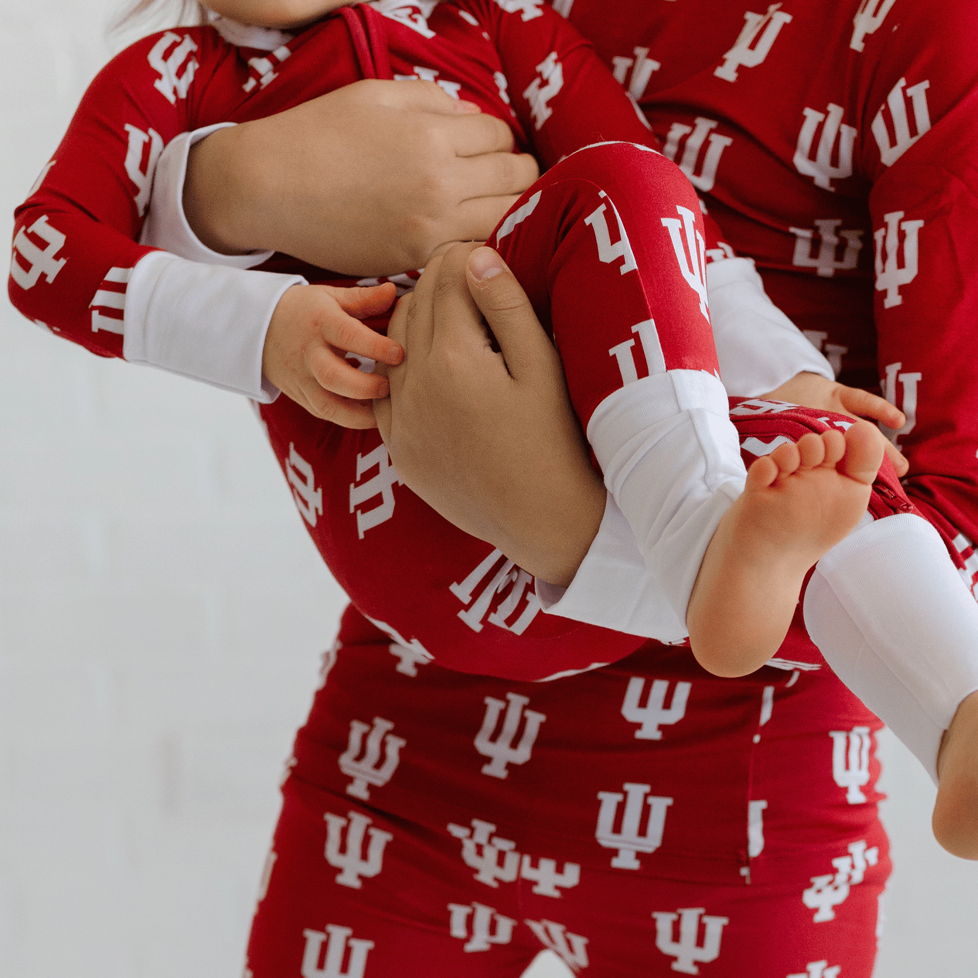 Indiana Hoosiers baby one-piece with official team logo, soft bamboo fabric, and double zippers for easy diaper changes.