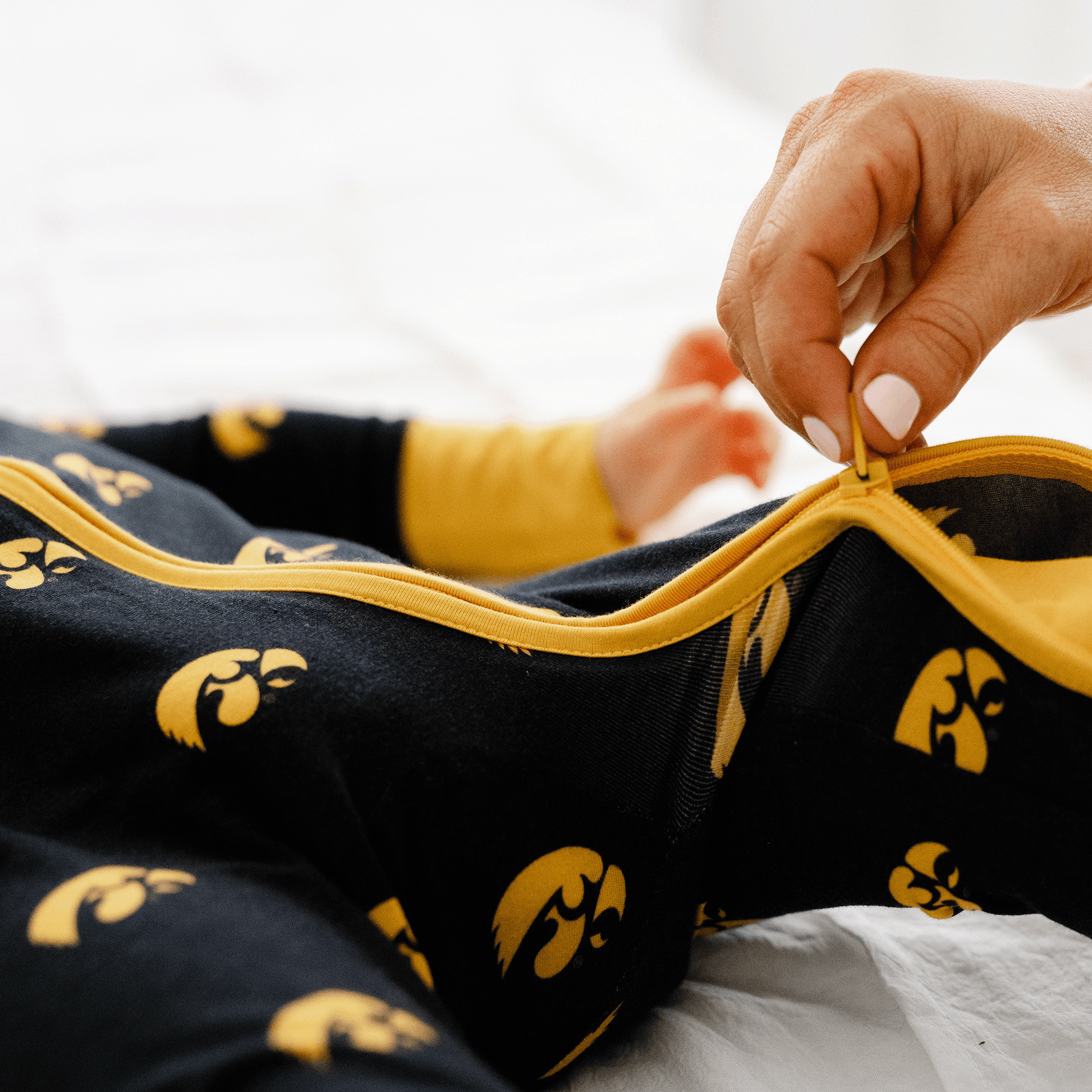 Iowa Hawkeyes one-piece with official team logo, soft bamboo fabric, and double zippers for easy diaper changes.