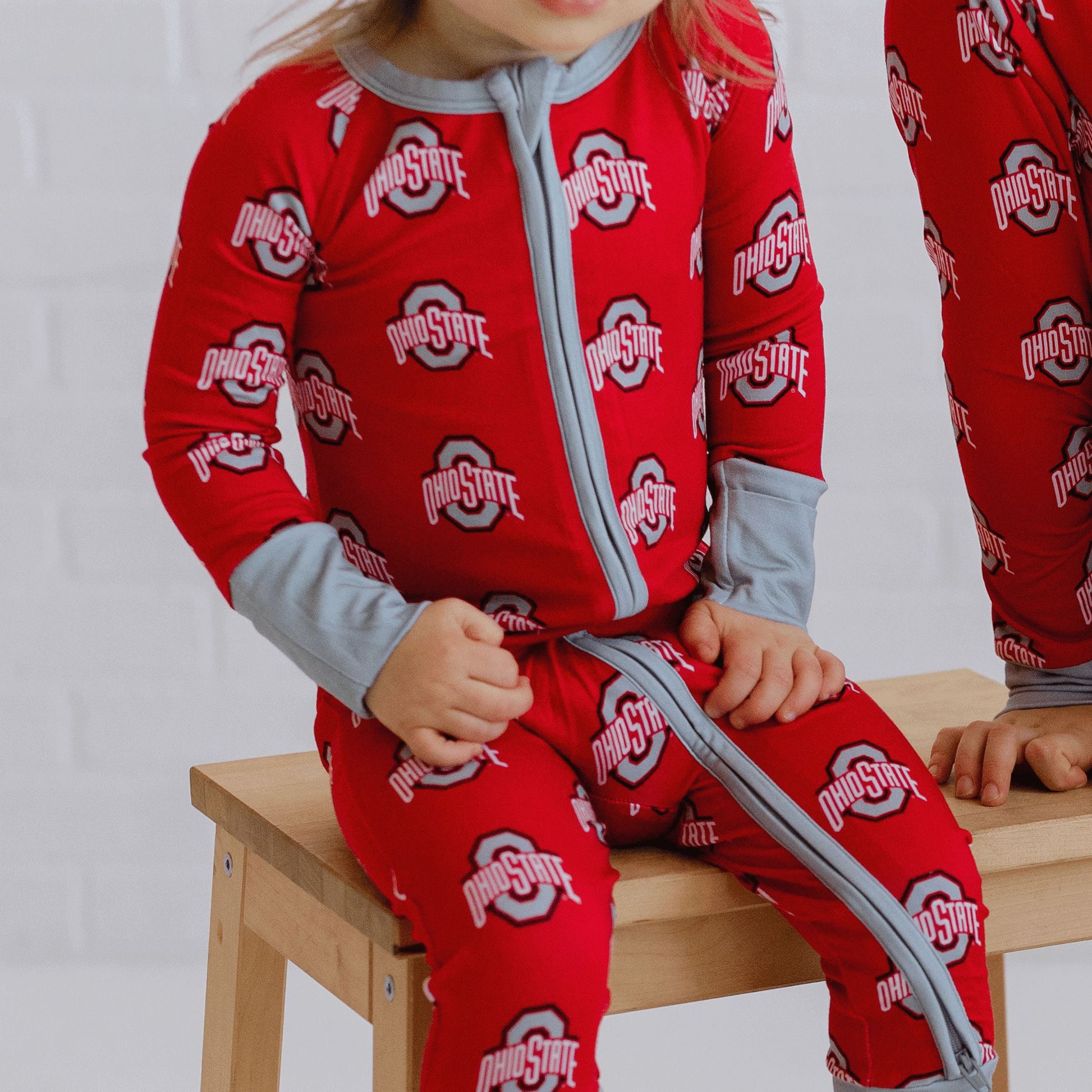 Ohio State Buckeyes one-piece with official team logo, soft bamboo fabric, and double zippers for easy changes.