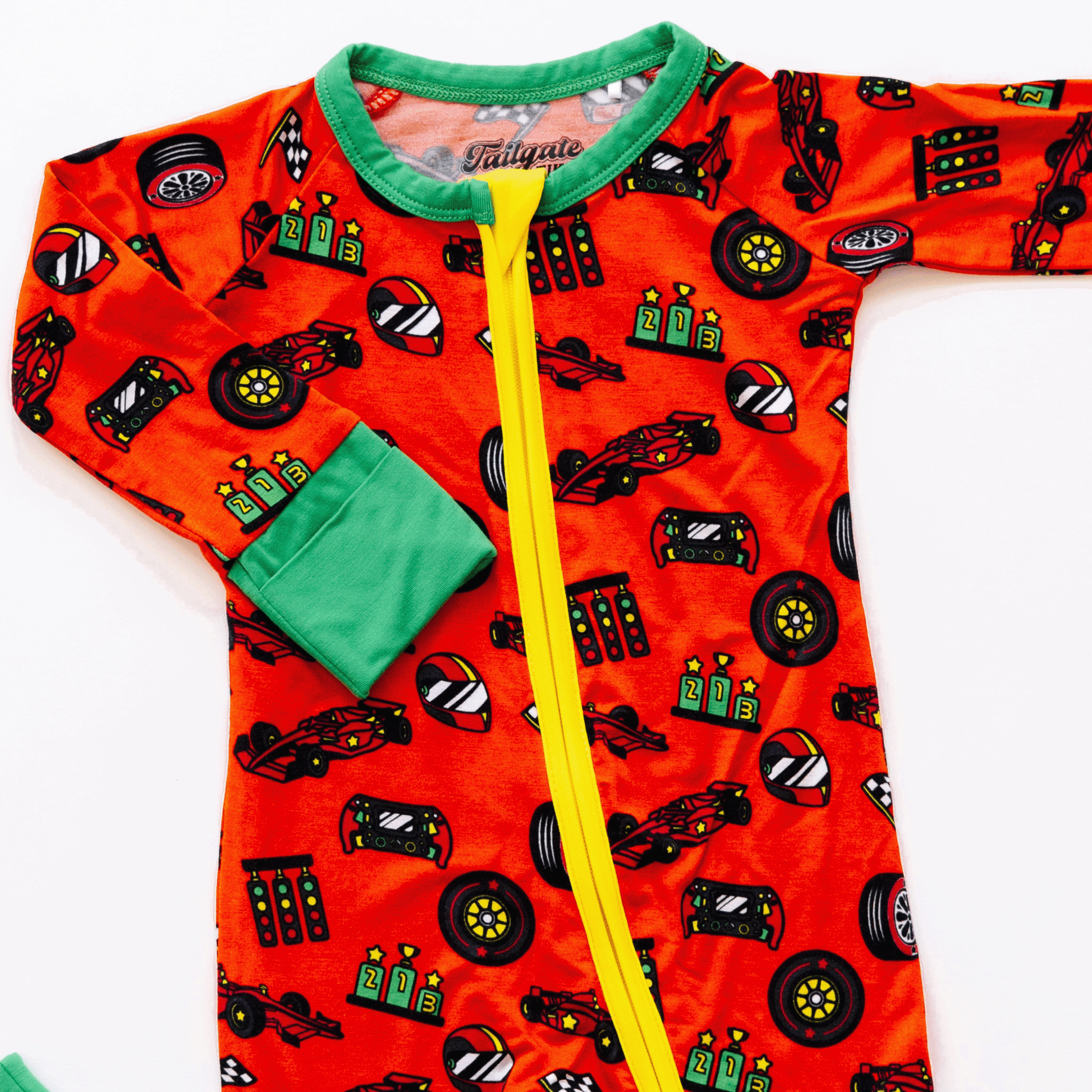 Racing-themed baby one-piece with soft bamboo fabric, double zippers for easy changes, and a sporty design for little racers.