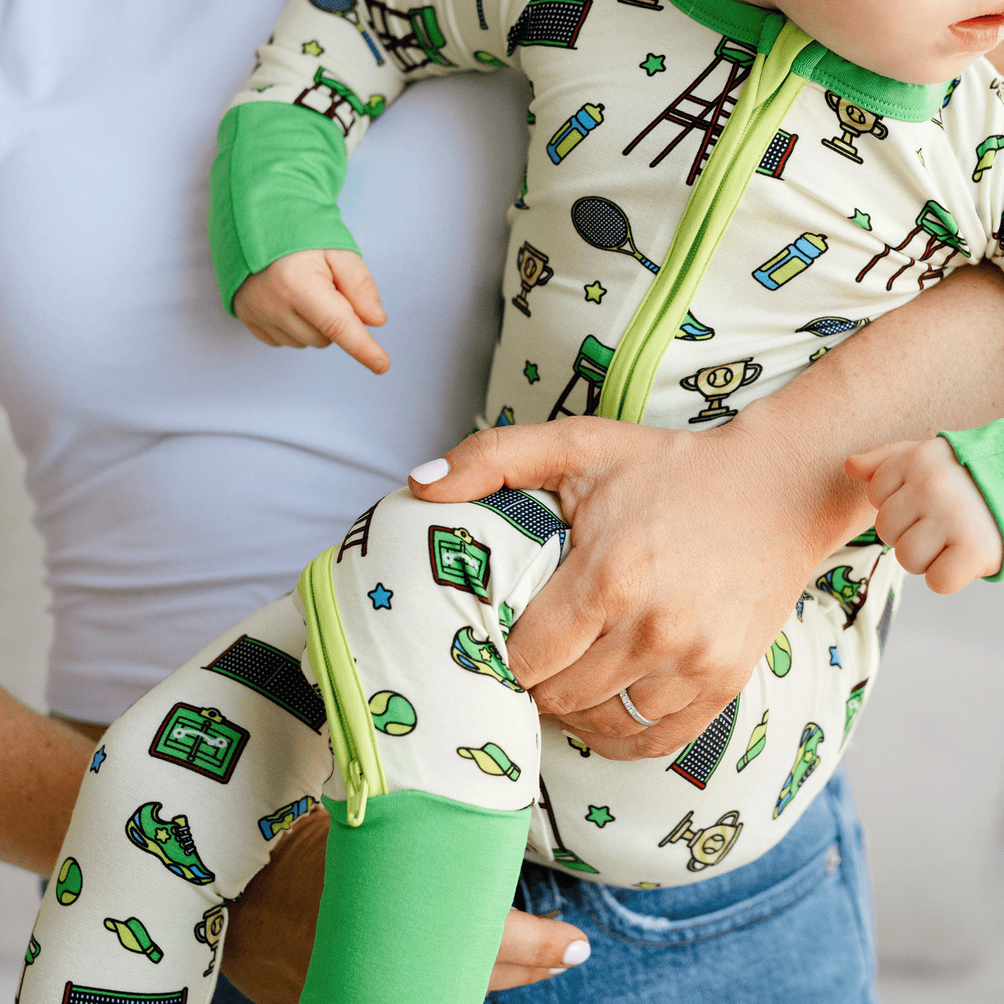 Tennis-themed baby one-piece with soft bamboo fabric, double zippers for easy changes, and a sporty design for little tennis fans.