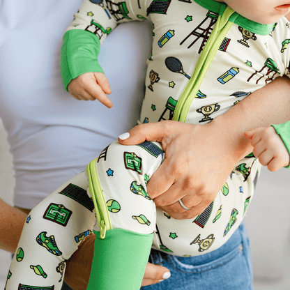 Tennis-themed baby one-piece with soft bamboo fabric, double zippers for easy changes, and a sporty design for little tennis fans.