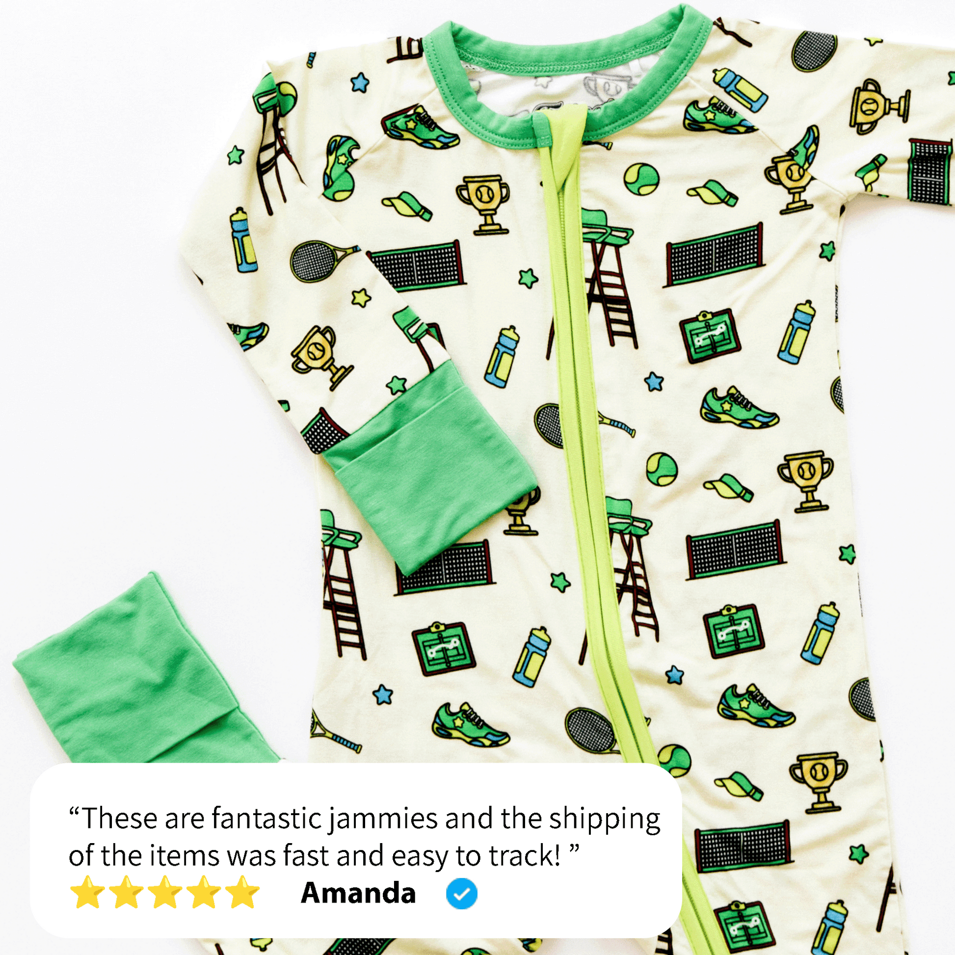 A green and white infant's zip-up onesie featuring sports-themed illustrations such as trophies, sneakers, and tennis rackets, next to a customer review. The review praises the quality and shipping speed of Tailgate Tikes' Tennis Onesie, rated five stars by Amanda.