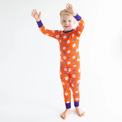 Clemson Tigers Toddler Wearing Clemson Tigers bamboo Pajama Set With Tiger Paw Print.