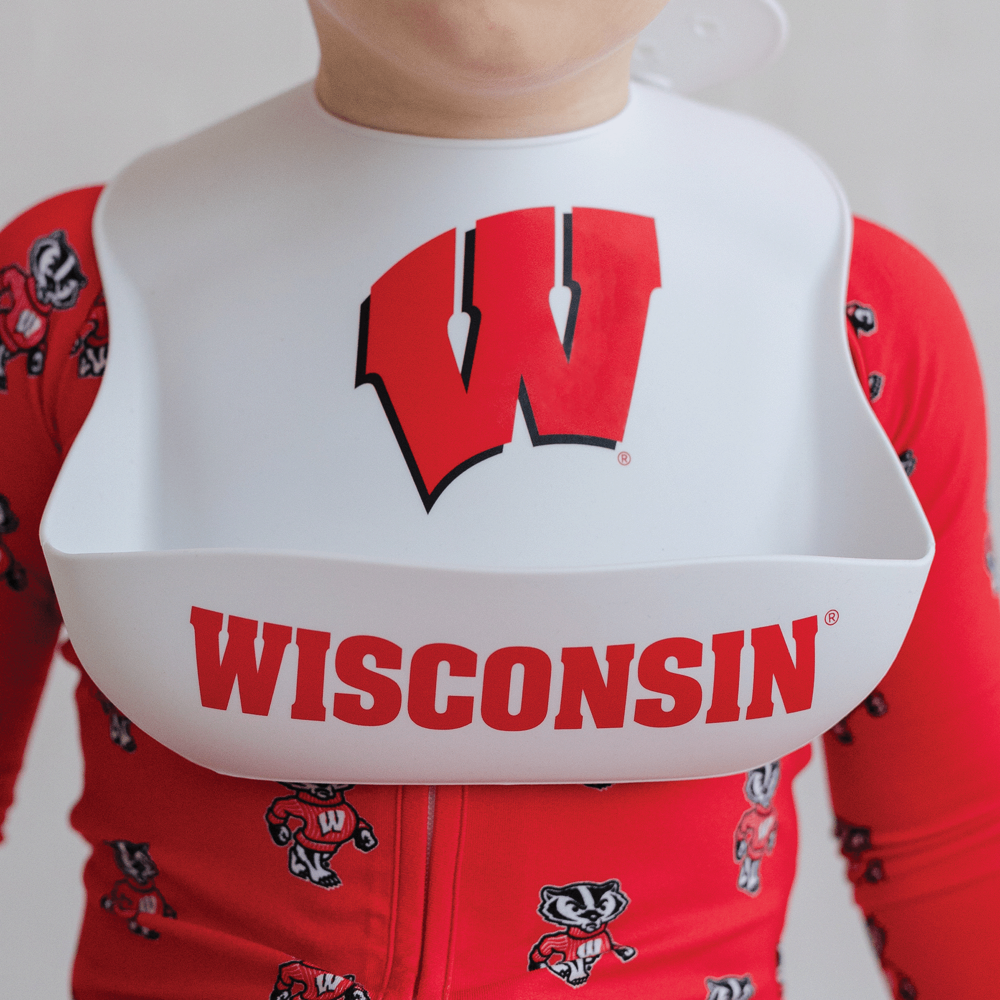 Wisconsin Badgers silicone baby bib, BPA-free, easy to clean, with adjustable fit, featuring the official team logo.