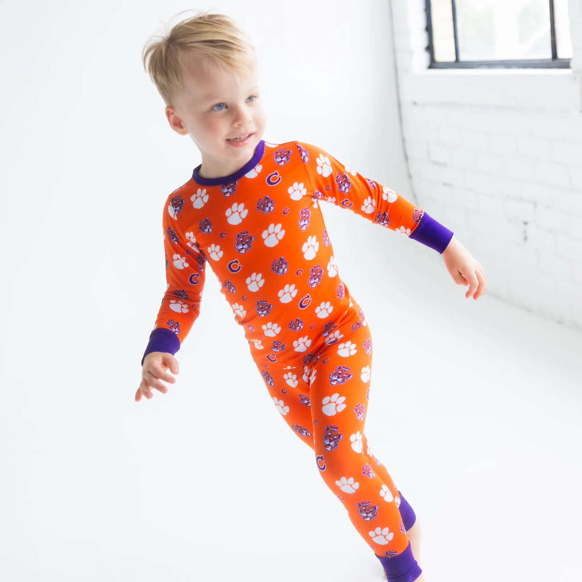 Clemson Youth Model In bamboo Clemson Pajamas Showing Stretch Waistband And Cuffed Pants.