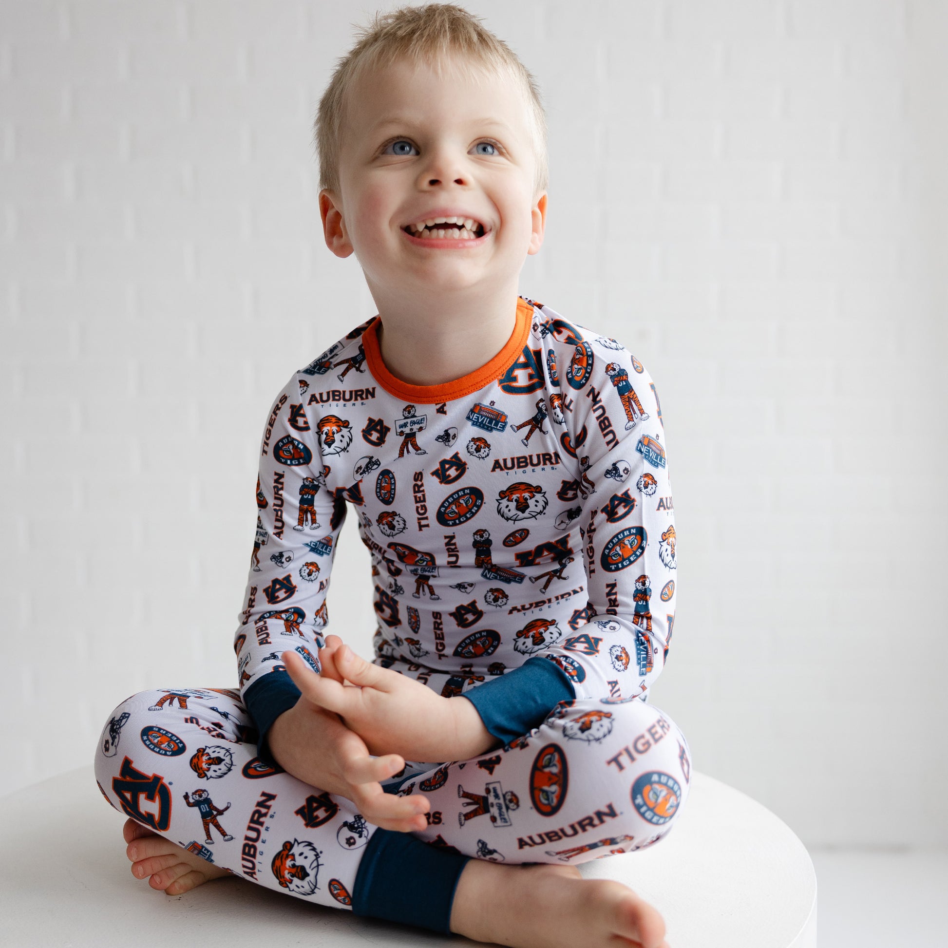 Toddler wearing Auburn Tigers two-piece pajama set with collegiate team print