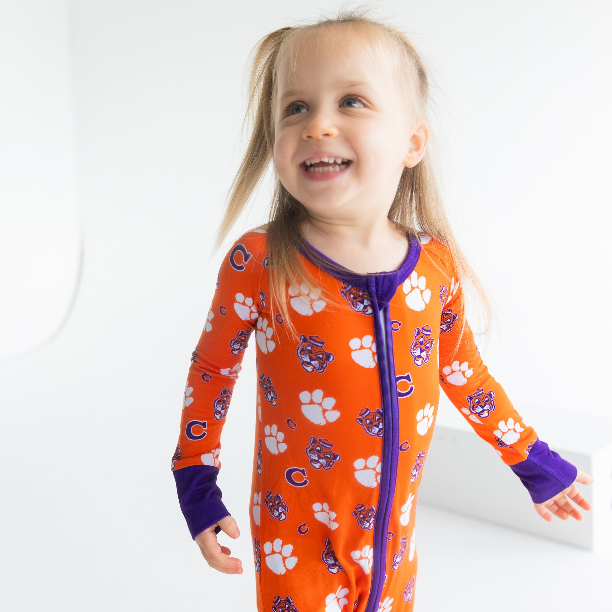 Clemson Tigers bamboo zippy pajamas for babies with orange and purple team branding