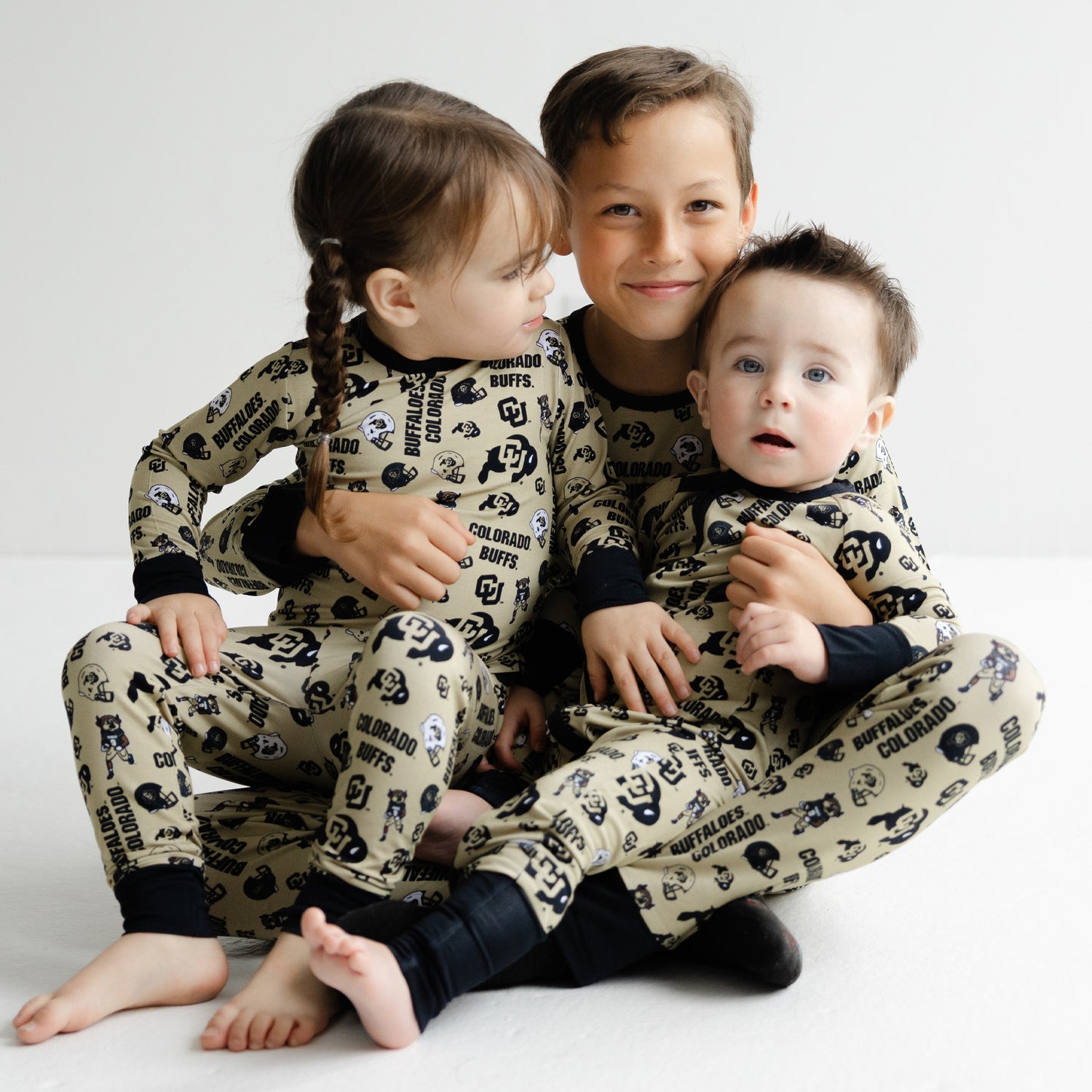 Colorado Buffaloes kids game day pajamas featuring multi-logo Buffs pattern