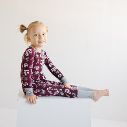 Toddler girl in a maroon Texas A&M Aggies zippy one-piece sleeper
