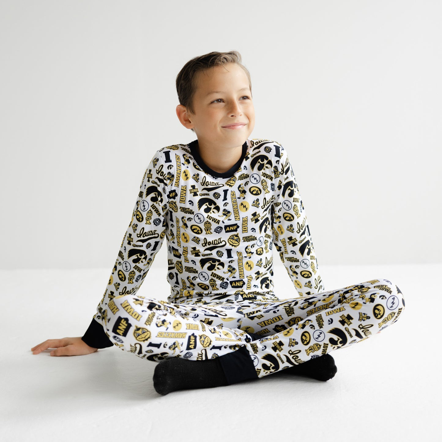 Iowa Hawkeyes white bamboo pajama set featuring all-over black and gold team branding