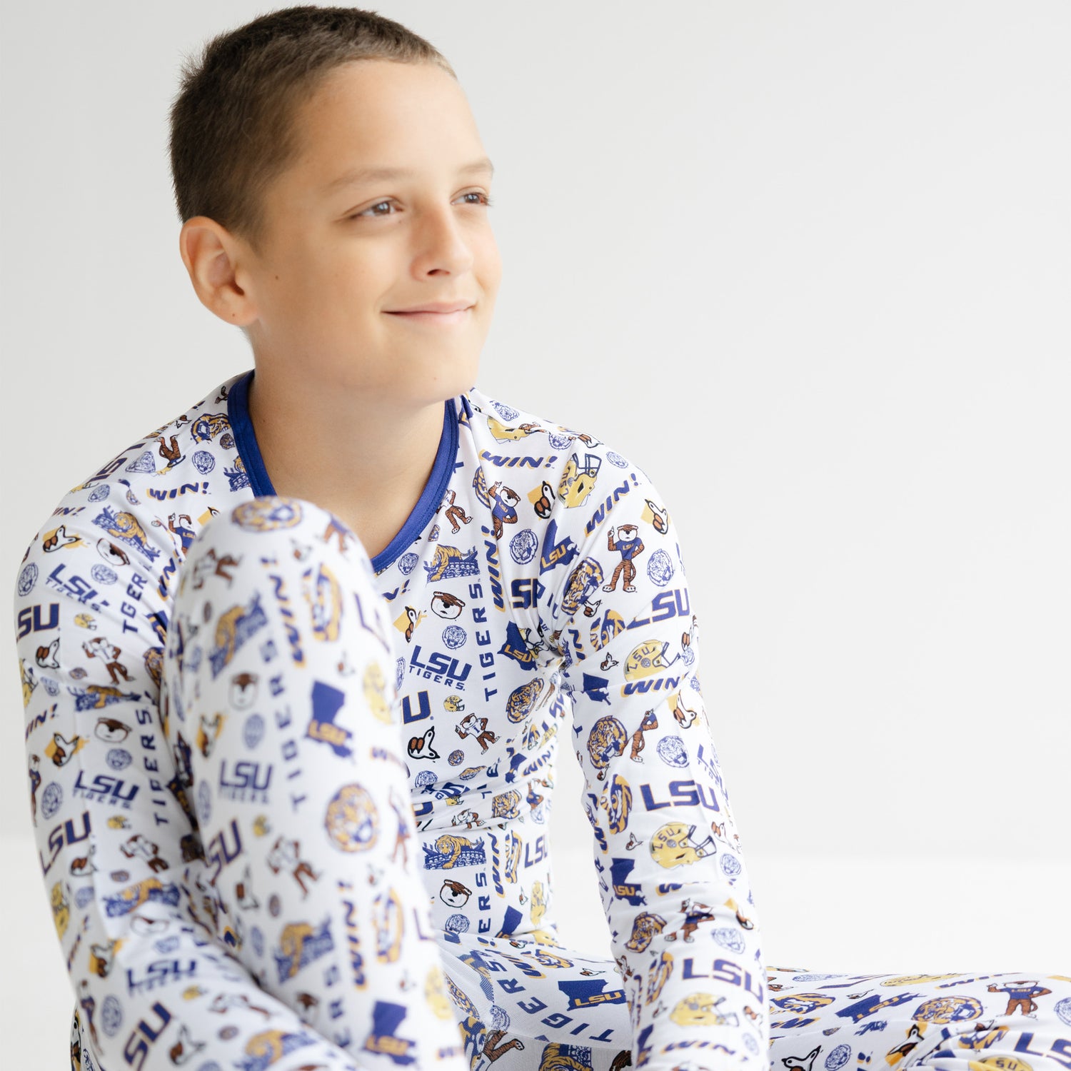 Kids LSU Tigers pajama set featuring purple and gold trim with iconic team logos
