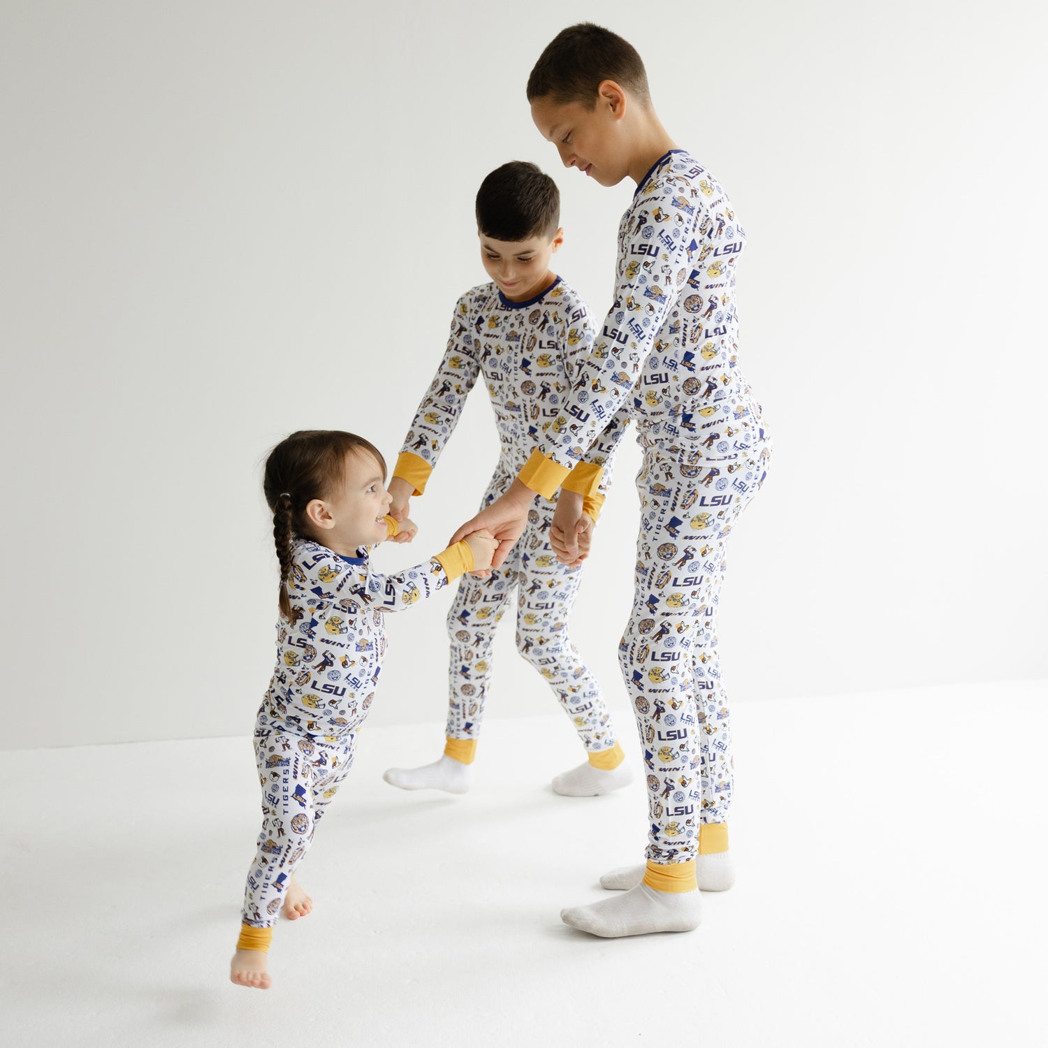 LSU Tigers bamboo baby and kids pajamas photo featuring officially licensed zippy one-piece sleeper and two-piece pajama set in purple and gold