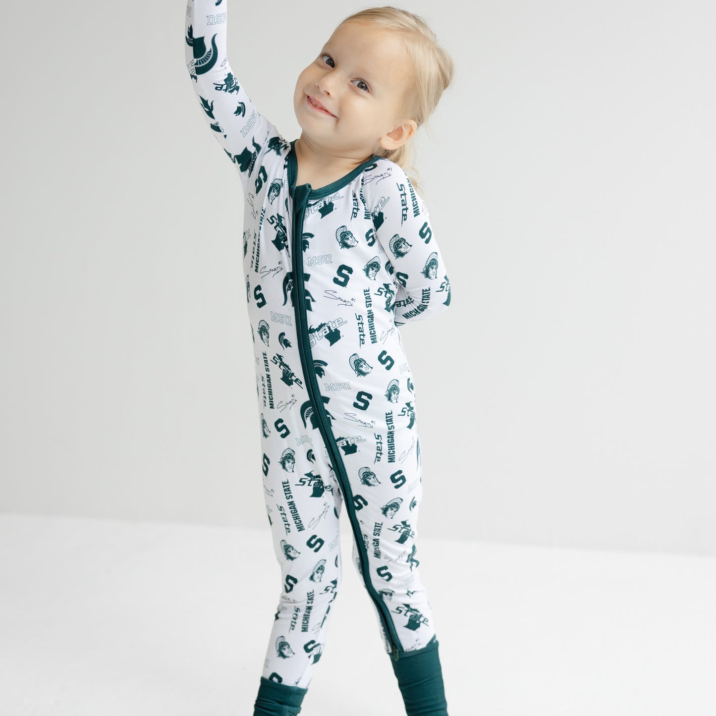 White Michigan State Spartans bamboo zipper one-piece for babies with soft green trim.