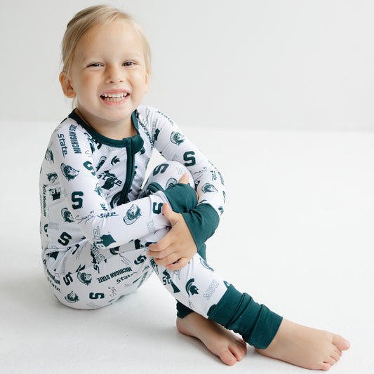 Michigan State Spartans bamboo zippy one-piece sleeper in white with green trim and officially licensed team logos.