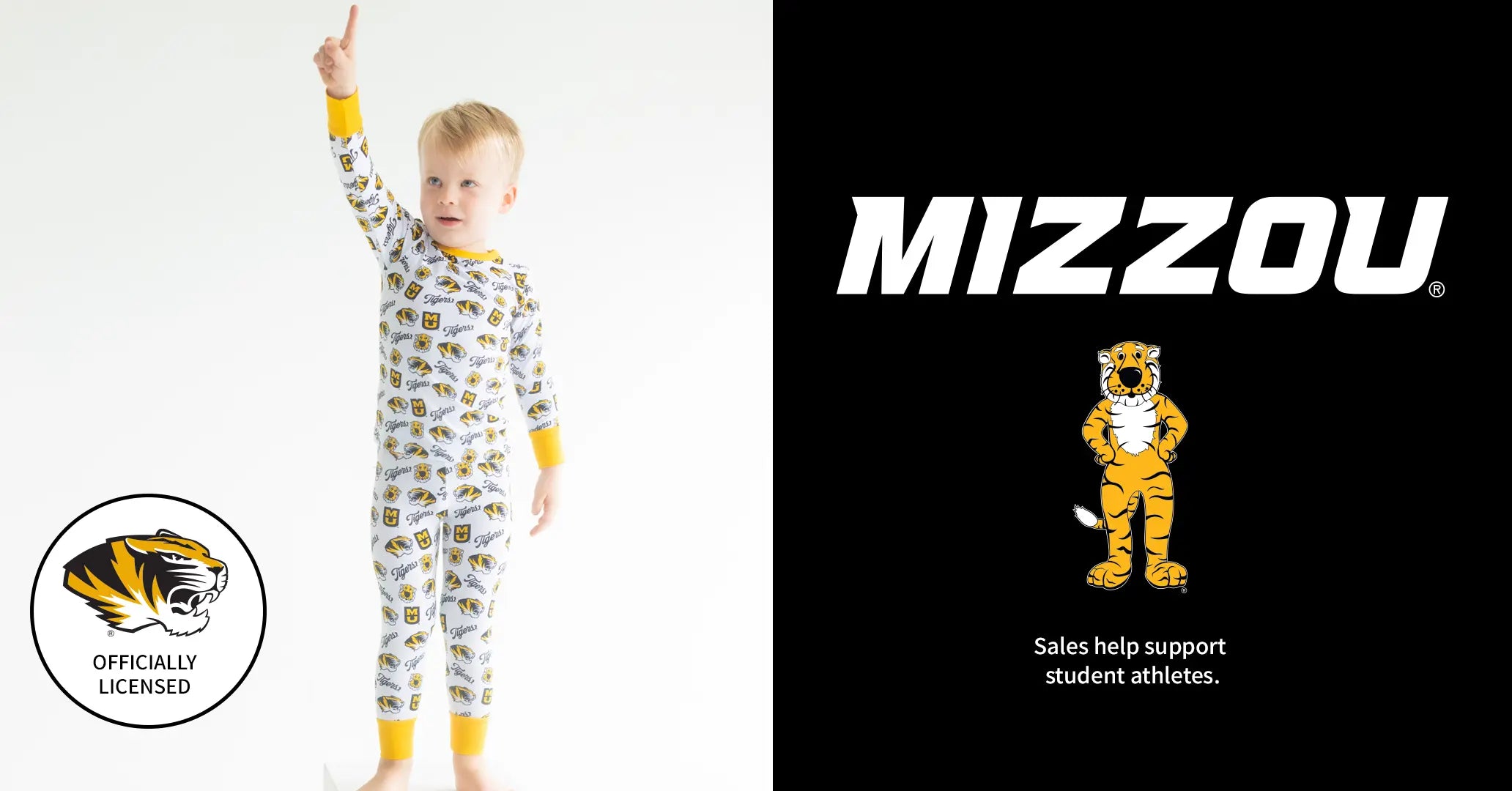 A child wearing a long-sleeve patterned pajama top and pants with yellow cuffs and hem stands against a white background, raising one arm. The pajamas have a white base with small yellow and blue graphic motifs.