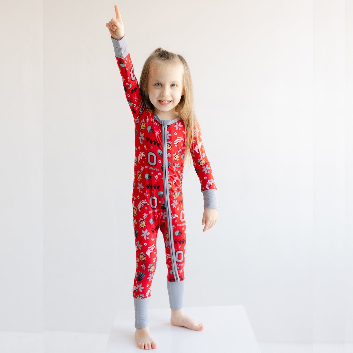 Front view of an Ohio State Buckeyes one-piece sleeper on a toddler