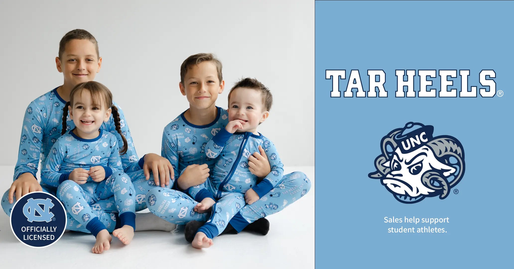Four children in blue pajamas with a UNC logo on a white background