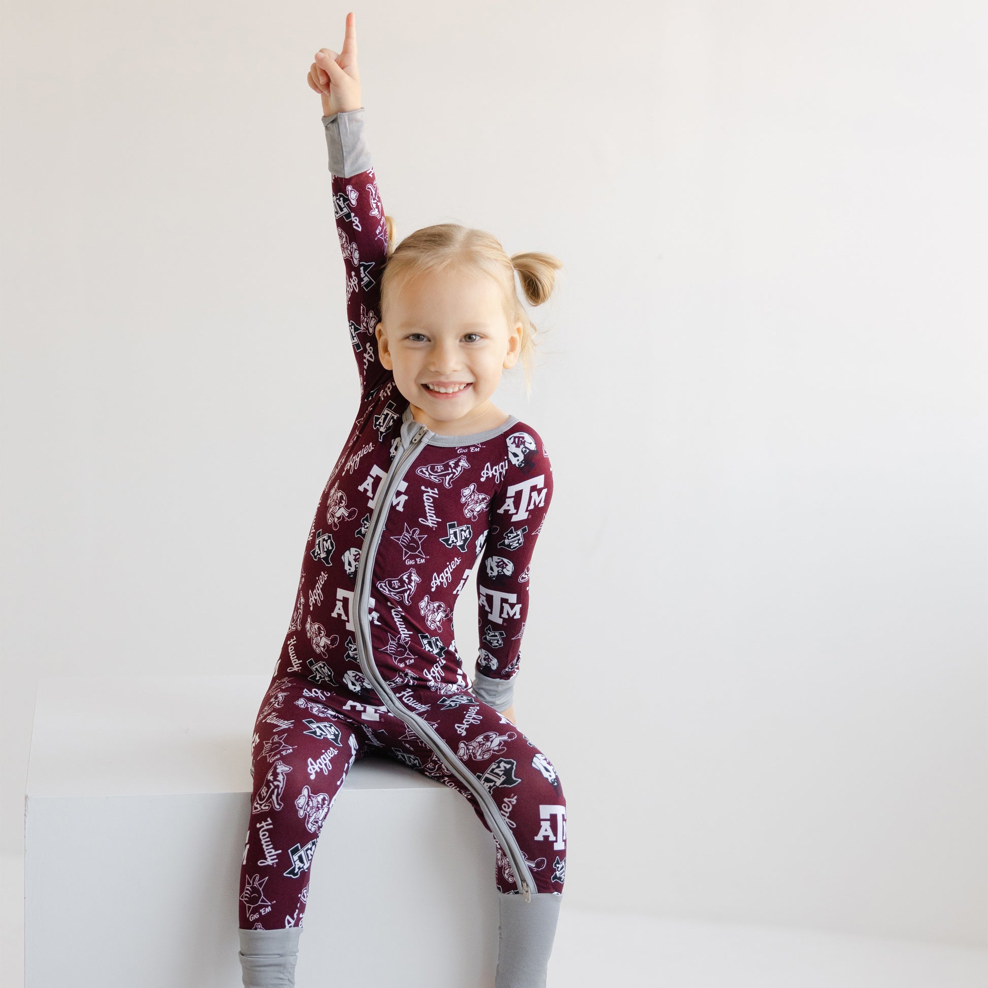 Toddler girl wearing Texas A&M Aggies pajamas on game day