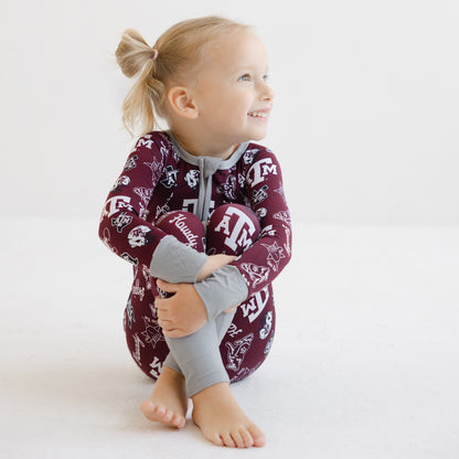 Toddler girl in a Gig 'em Aggies zippy one-piece sleeper