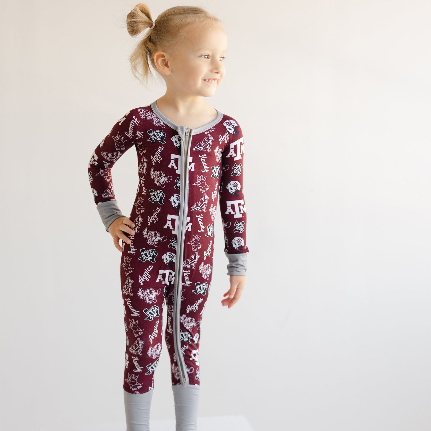 Toddler girl in Texas A&M Aggies sleeper at a family tailgate
