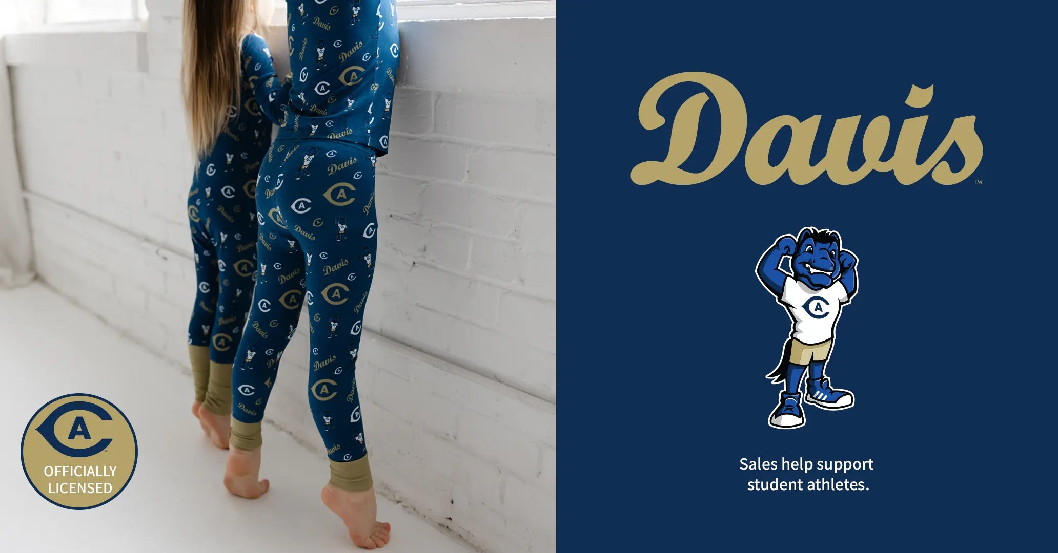 A child wearing a blue patterned long-sleeve pajama set stands barefoot against a white brick wall on the left, while the right side shows a navy panel with the word 'Davis' in gold and the Davis Dukes mascot logo with the text 'Sales help support student athletes.'.