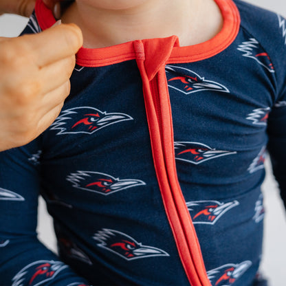 Close-up of a child wearing a navy UTSA roadrunners bamboo zipper one piece sleeper.