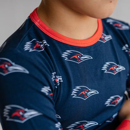 Close-up of a child wearing a navy utsa roadrunners bamboo two piece pajama set. 