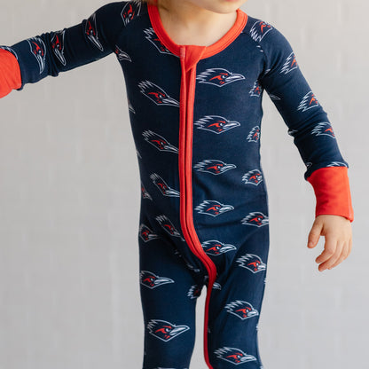 A baby wearing a navy UTSA roadrunners bamboo zipper one piece sleeper.