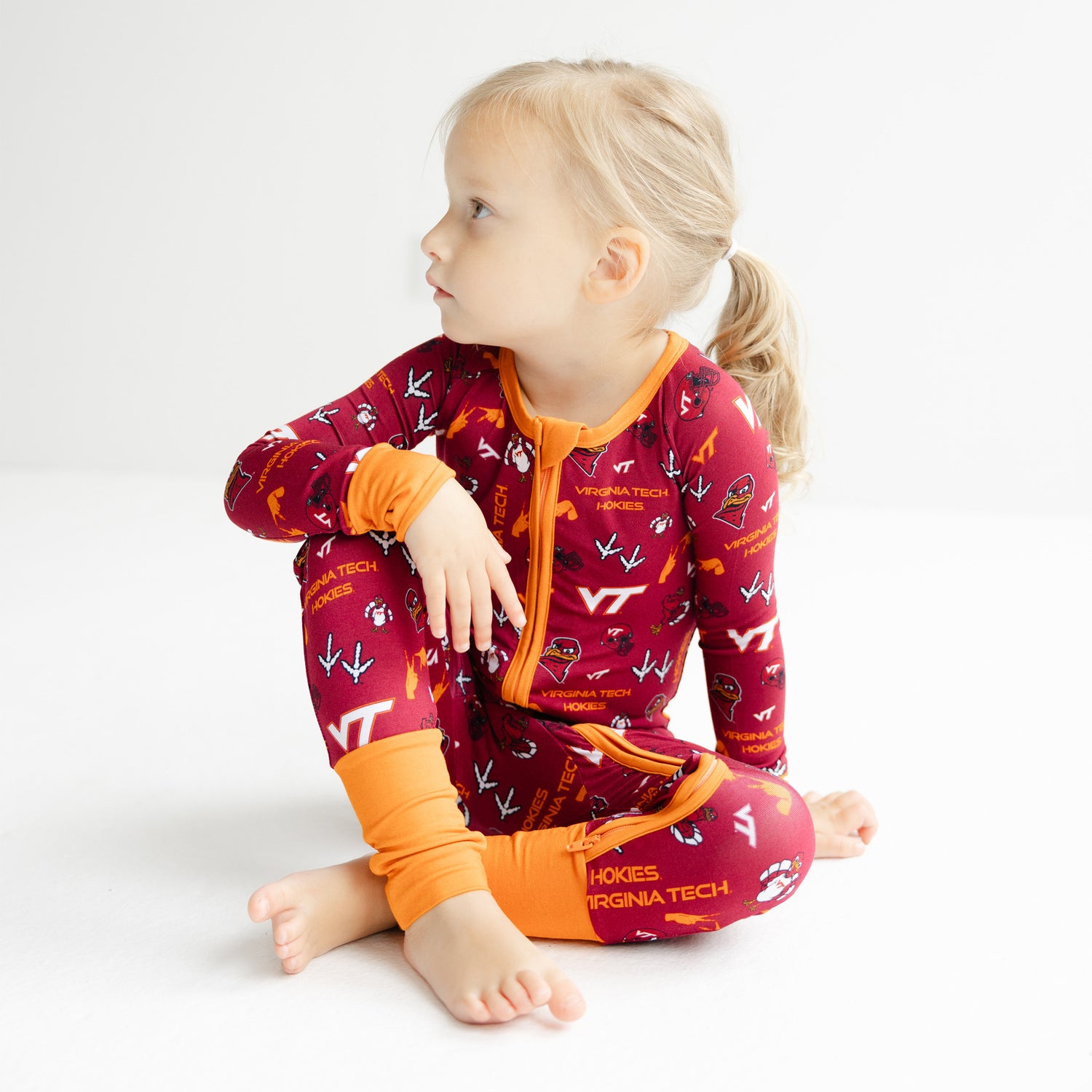 Virginia Tech Hokies bamboo zippy one-piece with Chicago Maroon background and Burnt Orange trim.