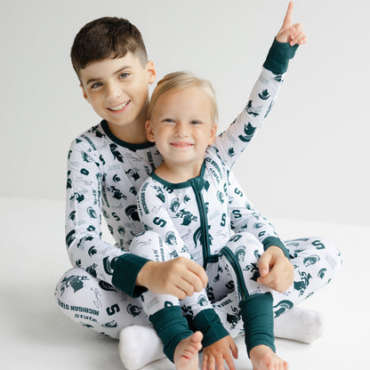 Michigan State Spartans newborn bamboo sleeper in white with green trim and team logo details.