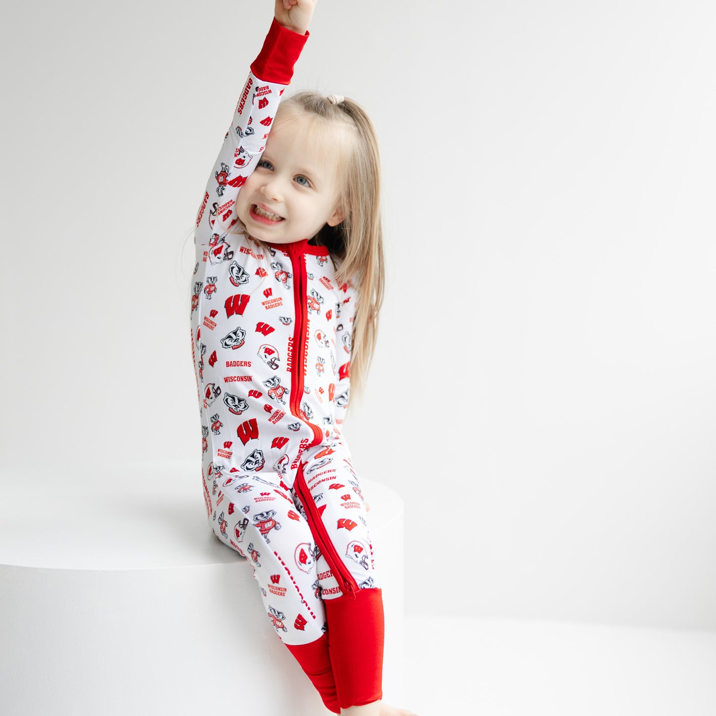 Baby Wisconsin Badgers zippy sleeper with red trim and collegiate multi-pattern print