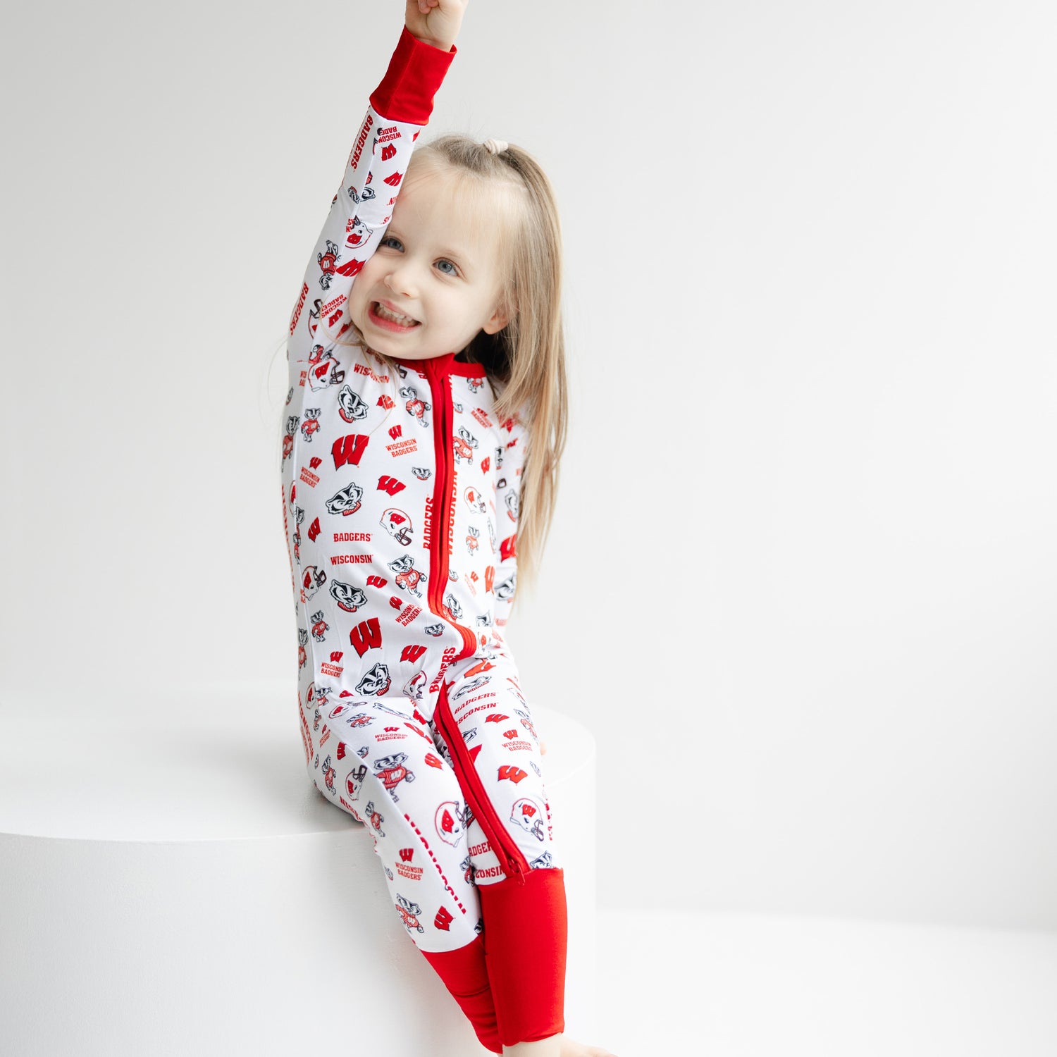 Baby Wisconsin Badgers zippy sleeper with red trim and collegiate multi-pattern print